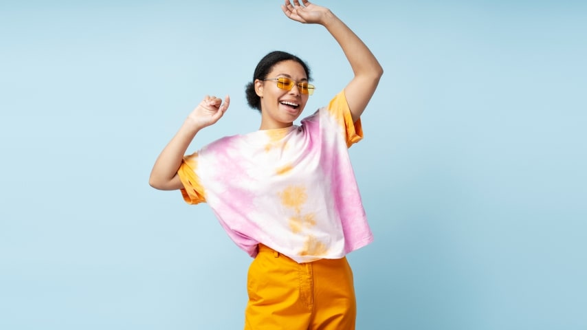 Benefits of Sublimation Printing A woman wearing a colorful AOP tie-dyed t-shirt.