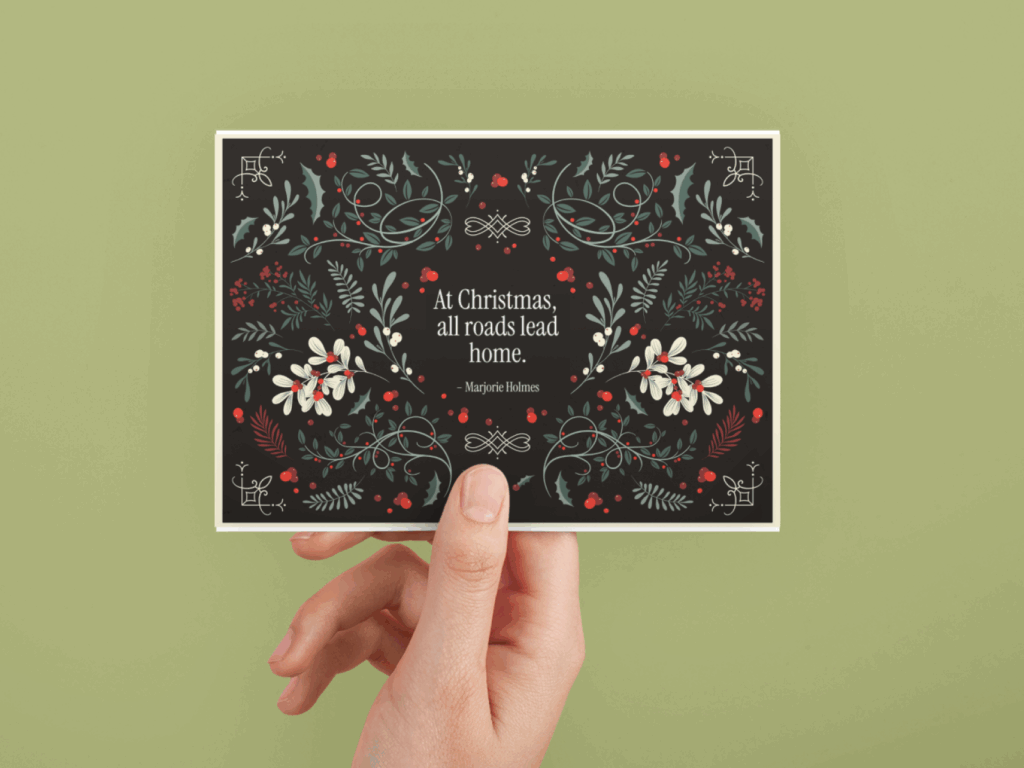 7 Holiday quotes for greeting cards A hand holds a card featuring a vibrant floral design against a neutral background.