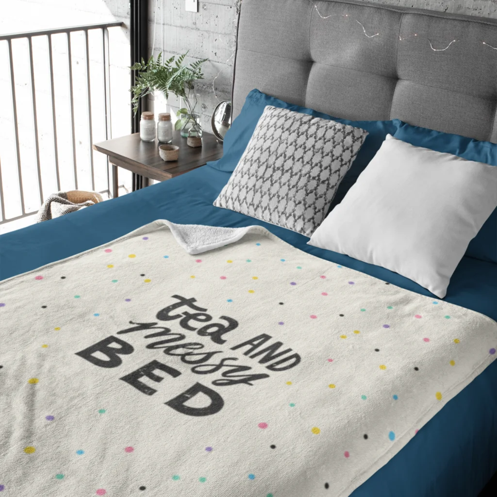 A custom blanket with a “Tea and messy bed” print.
