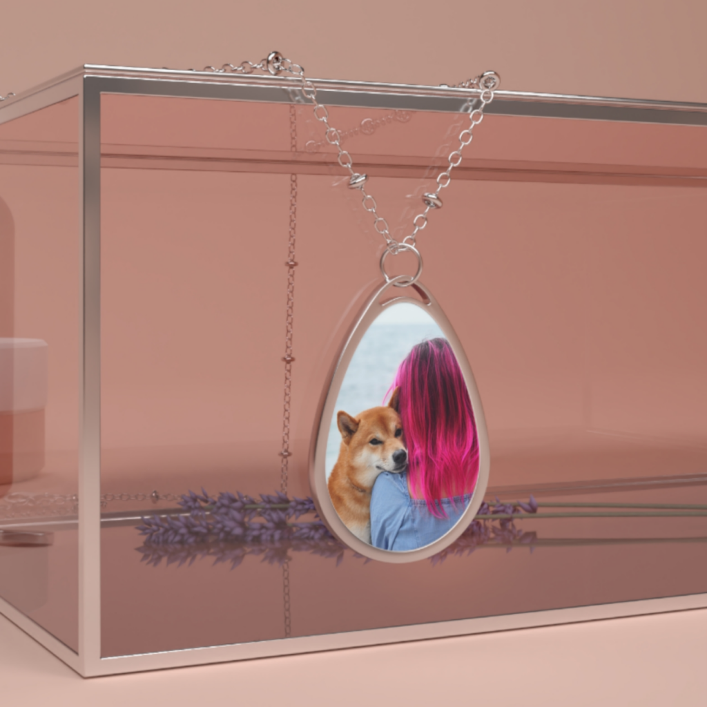 A custom necklace with a print of a dog and its owner.