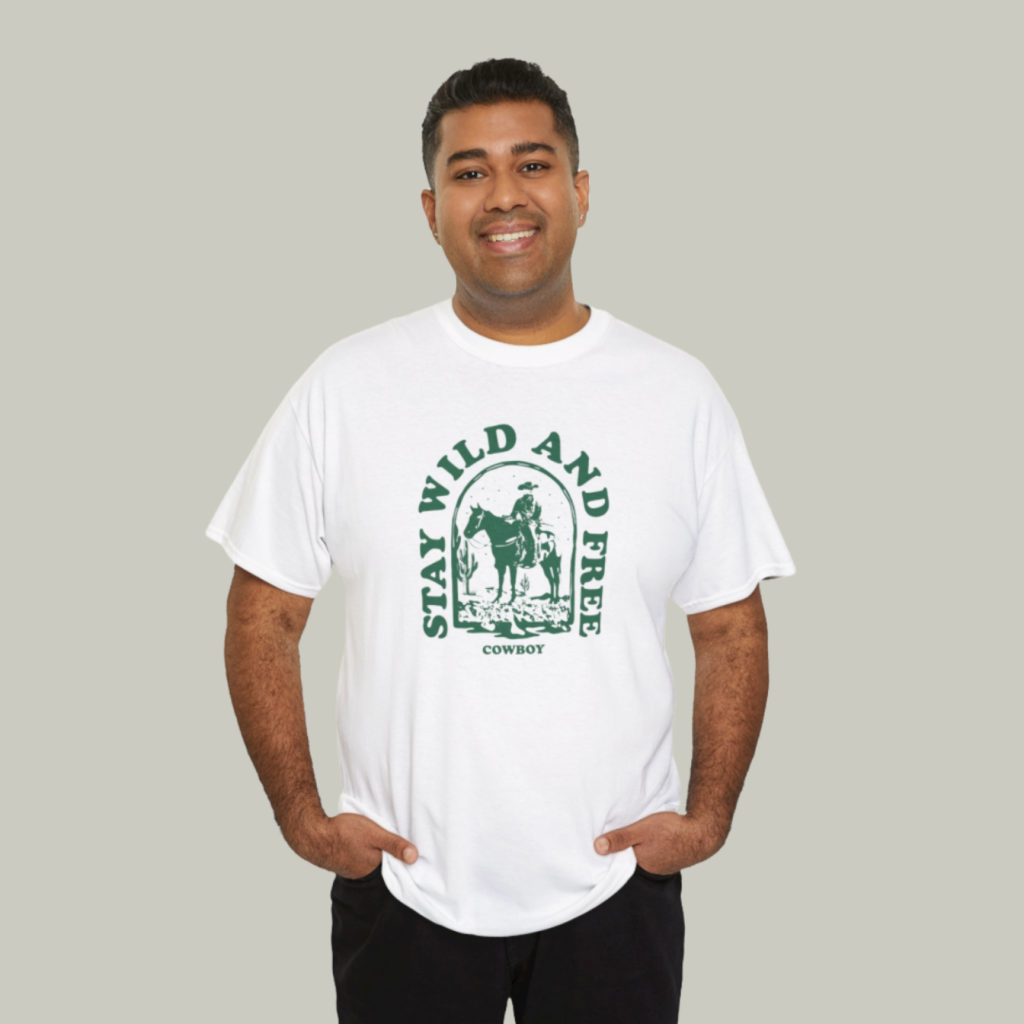 A mockup of a man wearing a t-shirt with a custom “Stay wild and free” print on a light-green background.