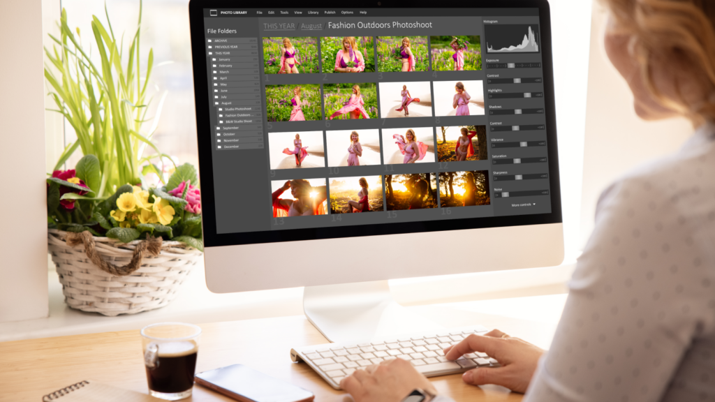 A woman editing images for Shopify on a large monitor.