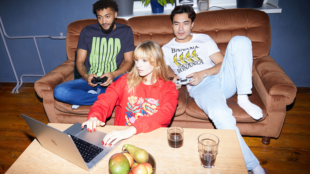 Popular DTF products from our Catalog A group of people (2 men and 1 woman) wearing custom apparel made with print-on-demand.