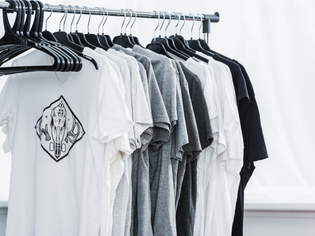 Multiple custom t-shirts on hangers.
