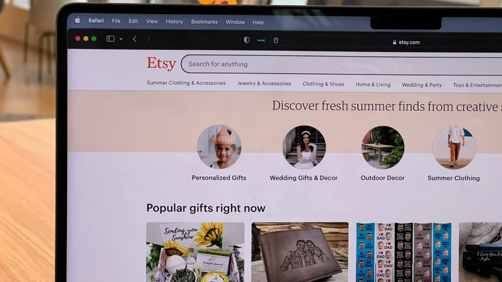 A laptop screen with Etsy’s homepage cornershot.