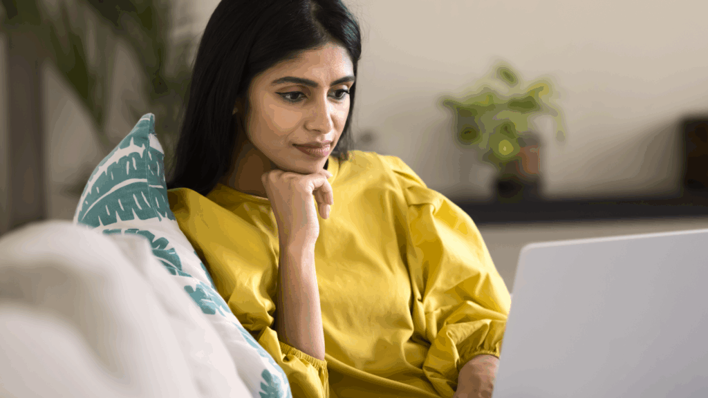 Which t shirt printing method to choose A woman is reading from a laptop screen.