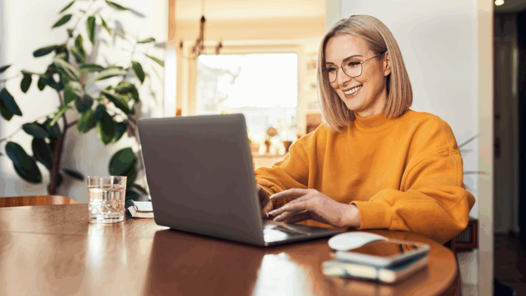 Why these trends matter A woman wearing glasses sits at a table, focused on her laptop while working or studying.